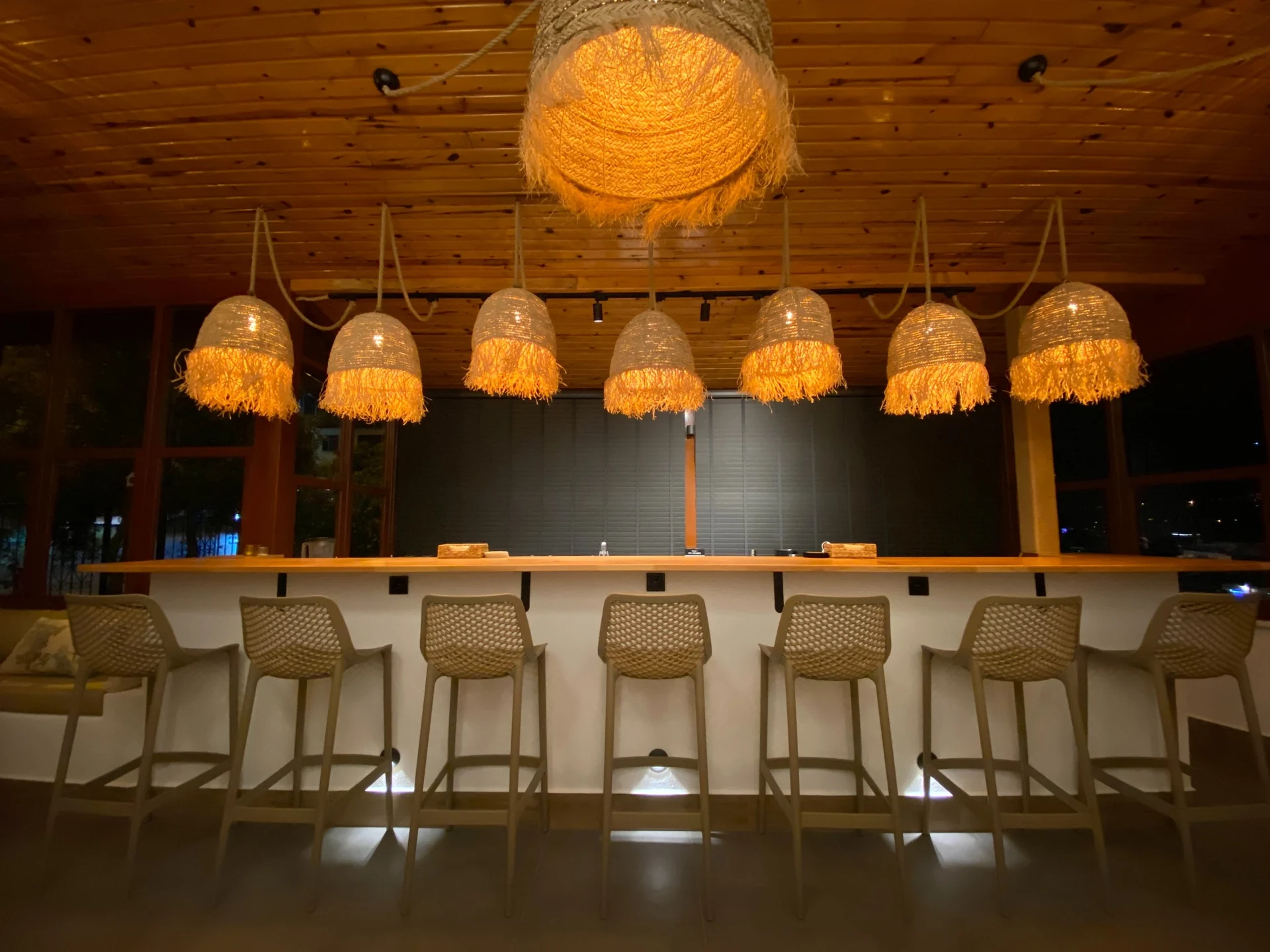 Casa Vagabundo bar counter under woven pendant lights